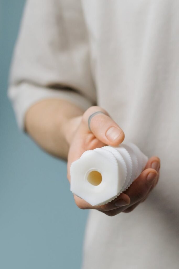 Close-Up Shot of a Person Holding a White Sex Toy