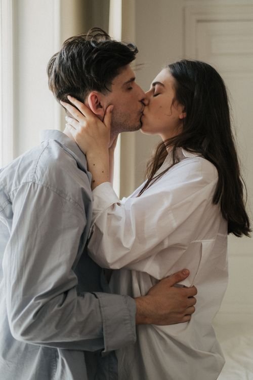 Couple embracing and kissing, expressing tenderness and love