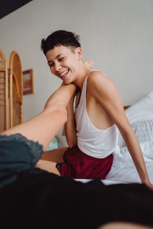 Playful couple laughing together in a close, affectionate moment