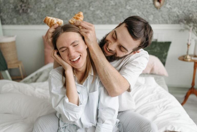 Couple enjoying a fun cozy morning in bed together