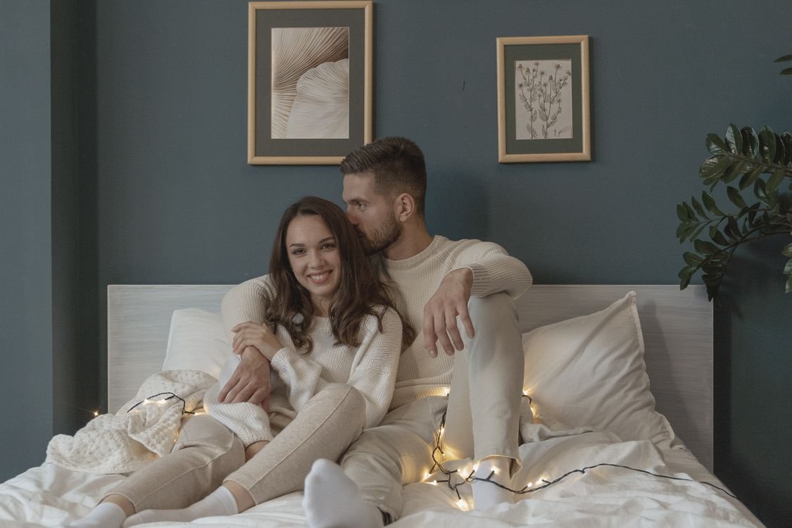 Loving couple enjoying a cozy bedroom evening together